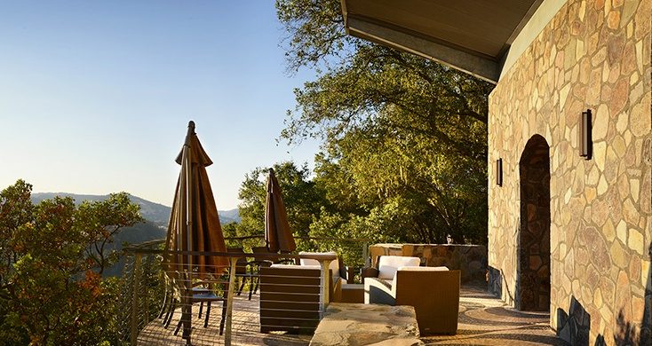 balcony with patio furniture overlooking a vineyard